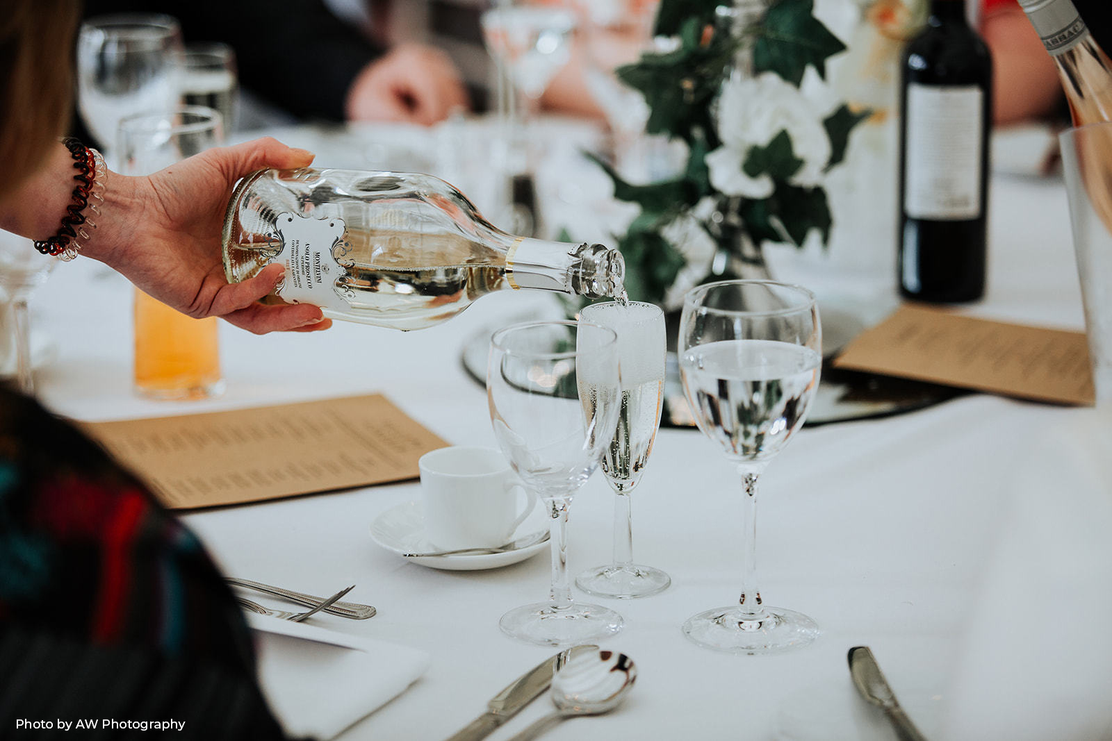 Waiter pouring a glass of champagne at a Christmas party at Hilltop Country House. Photo by AW Photography.