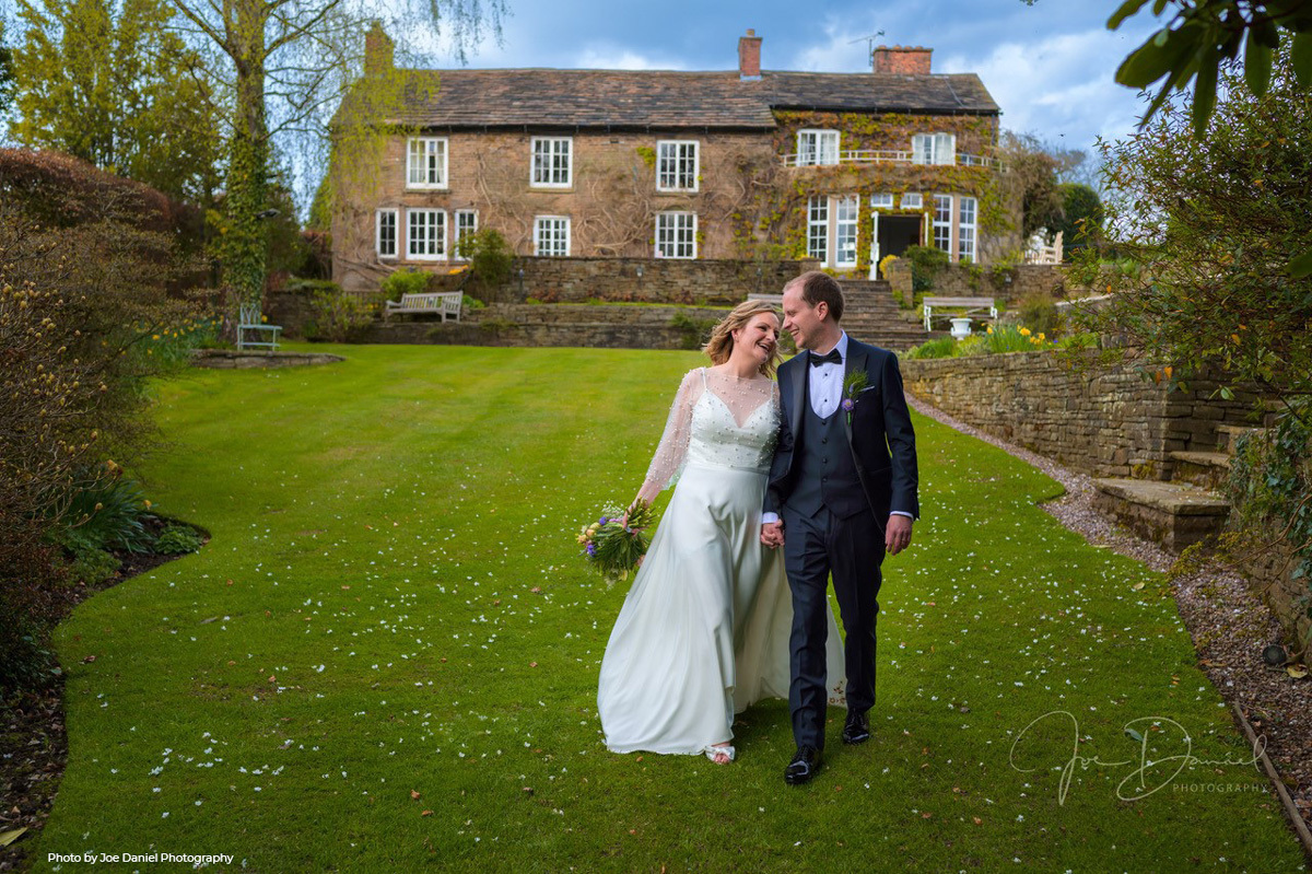 Bride and groom walking through the garden at Easter in Hilltop Country House